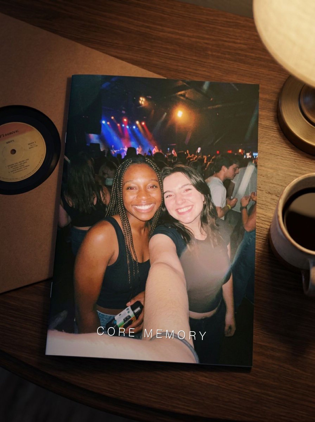 The zine on a bedside table with coffee and a record