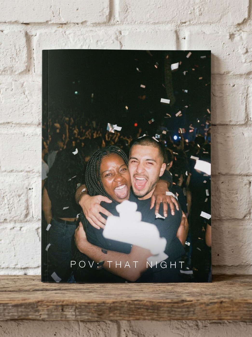 The zine on a shelf — confetti cover